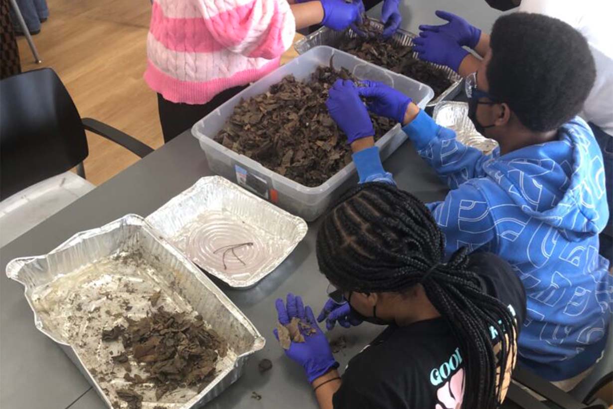 Local high school students sort through LittaTrap samples to find macroplastics